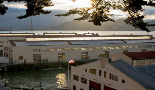 Sun Light highlighting Clerestory Windows of Historic Pier Buildings with Golden Gate Bridge in the background